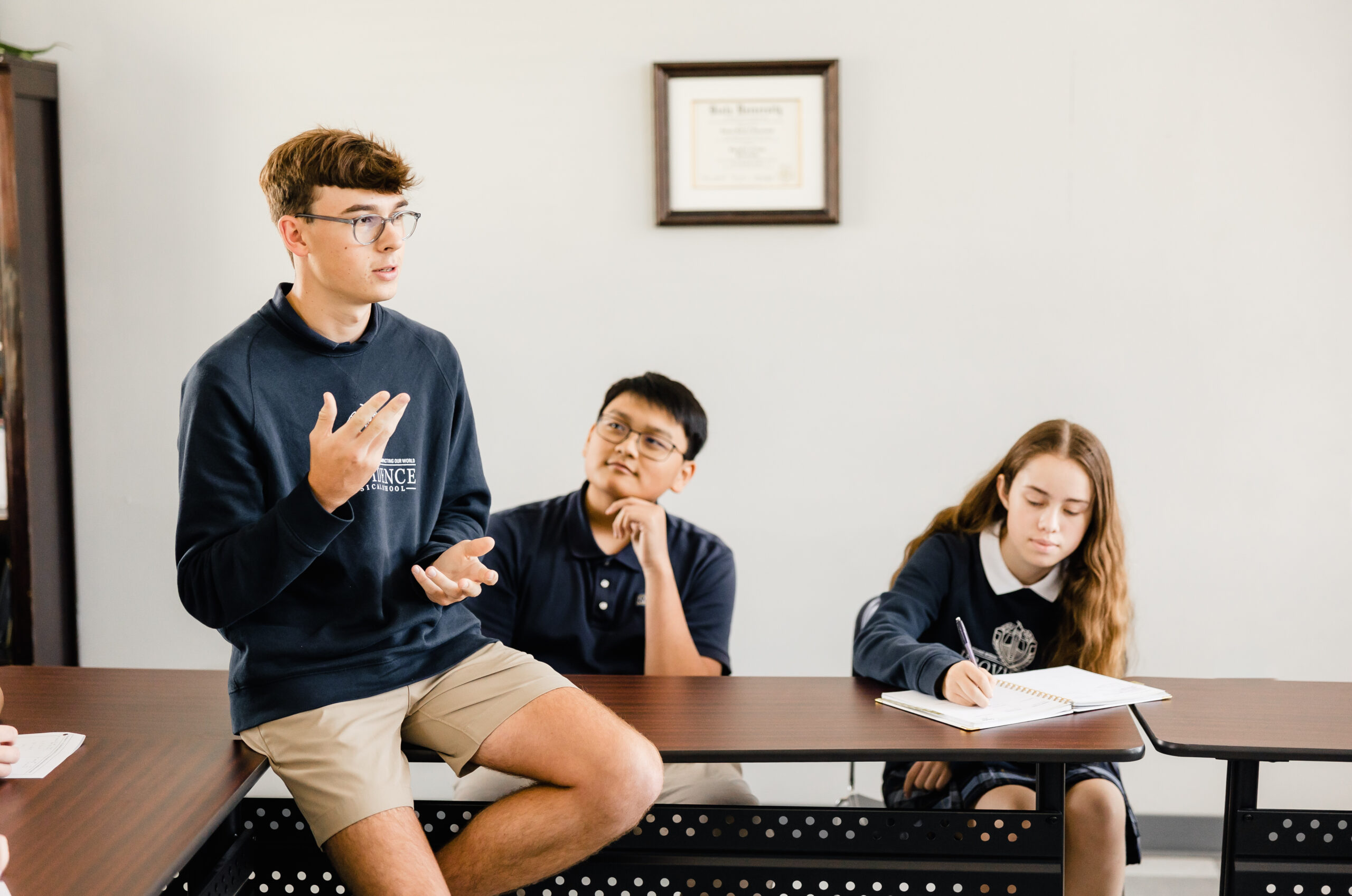 Student leads a discussion with classmates at Providence Classical School in Klein, TX.